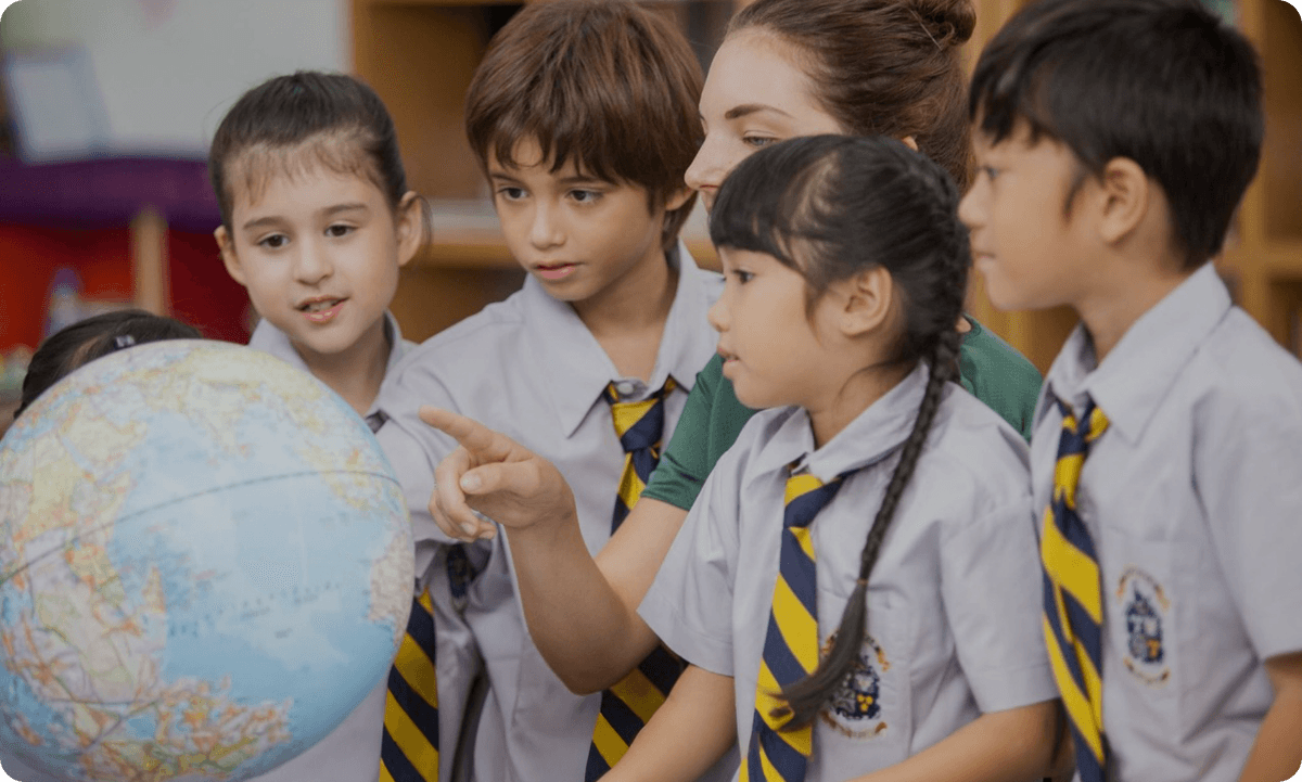 Students and teacher around a globe